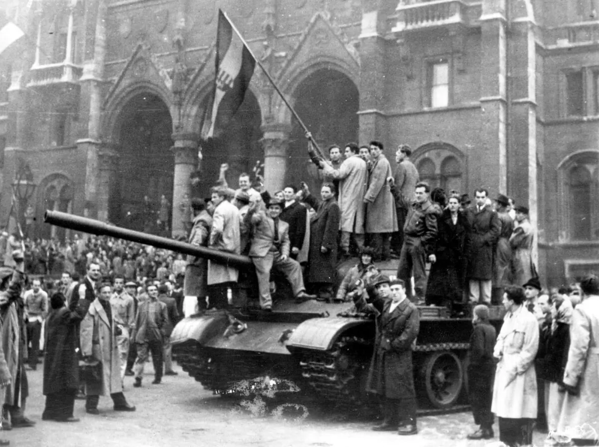 Civilians wave Hungary’s national flag from a captured Soviet tank in Budapest’s main square during the anti-communist uprising of October 1956. (AP Photo)