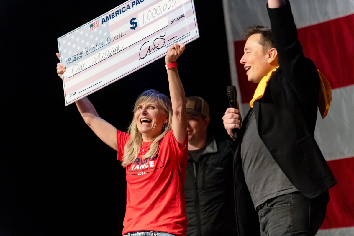 SpaceX and Tesla founder Elon Musk awards Kristine Fishell a $1 million check during a town hall at the Roxian Theatre in Pittsburgh on Oct. 20, 2024. (Michael Swensen/Getty Images)