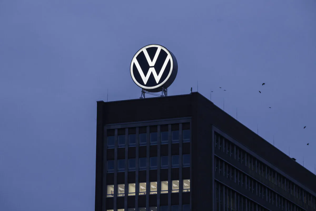 The Volkswagen logo stands illuminated at dusk on the main administrative building at the Volkswagen automobile factory in Wolfsburg, Germany, on Oct. 28, 2024. (Sean Gallup/Getty Images)