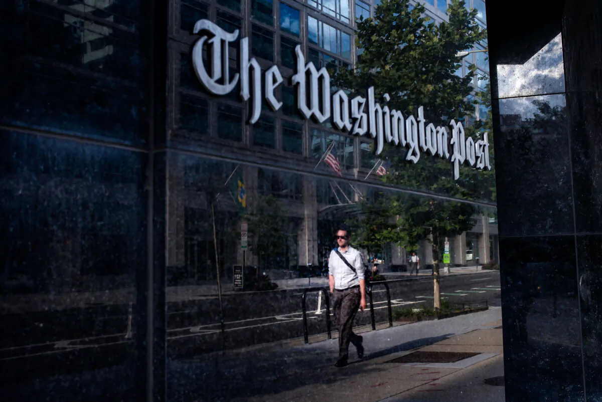 A man walks past The Washington Post building in Washington in a file photo. (Brendan Smialowski/AFP via Getty Images)