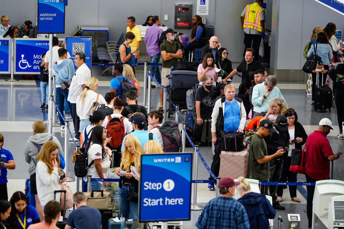 Travelers wait at the departure area check-in at the United Airlines terminal at Los Angeles International airport in Los Angeles on June 28, 2023. (Damian Dovarganes/AP Photo)