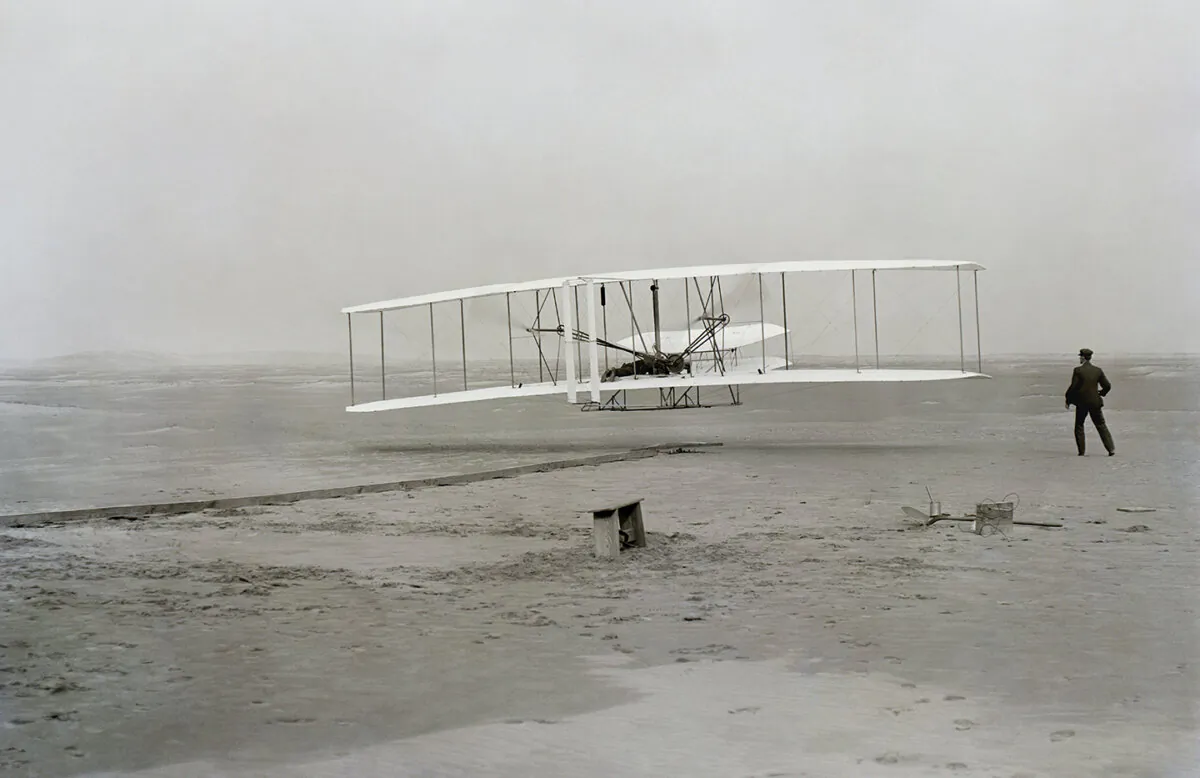 First successful flight of the Wright Flyer, by the Wright brothers and engine mechanic Charlie Taylor on Dec. 17, 1903. Library of Congress. (Public Domain)