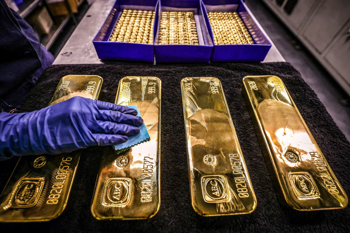 A worker polishes gold bullion bars at the ABC Refinery in Sydney, Australia, on Aug. 5, 2020. (David Gray/AFP via Getty Images)