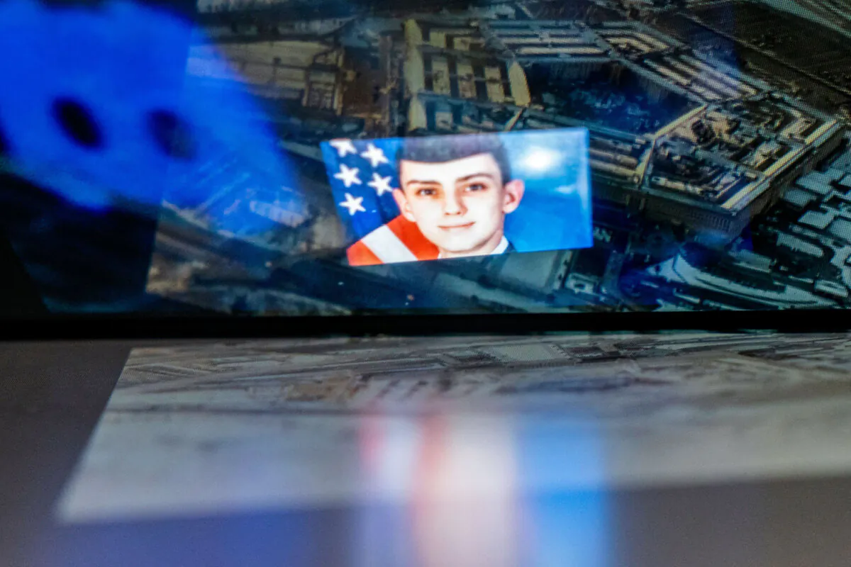 The Discord logo and the suspect, national guardsman Jack Teixeira, reflected in an image of the Pentagon in Washington on April 13, 2023. (Stefani Reynolds/AFP via Getty Images)