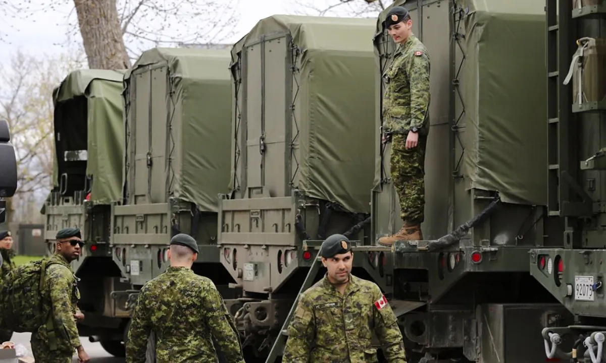 Reservists pack military vehicles with boats and fuel at CFB Kingston in Kingston, Ont., on May 9, 2017. (The Canadian Press/Lars Hagberg)