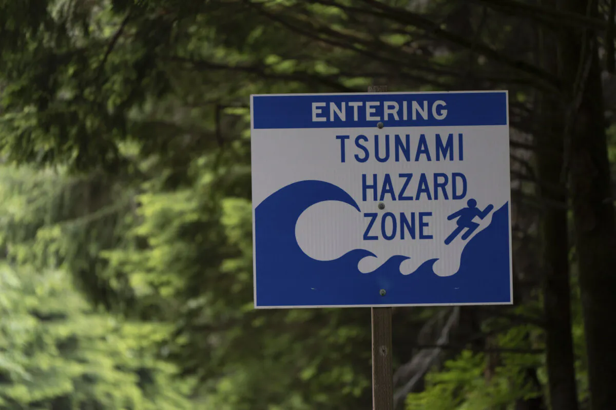 A sign warning drivers that they are entering a tsunami hazard zone is displayed along U.S. Route 101, north of Lincoln City, Ore., on June 14, 2024. (AP Photo/Jenny Kane)