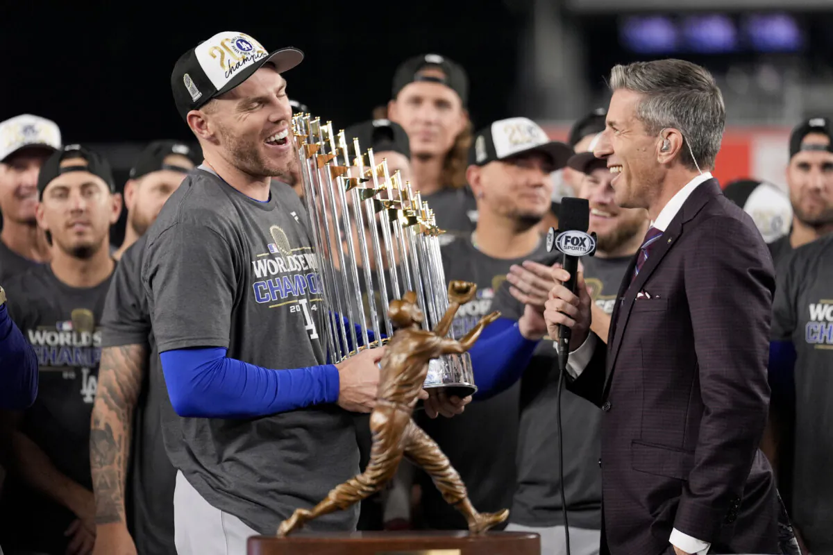Los Angeles Dodgers' Freddie Freeman celebrates with the trophy after their win against the New York Yankees in Game 5 to win the baseball World Series, in New York on Oct. 31, 2024. (Ashley Landis/AP Photo)