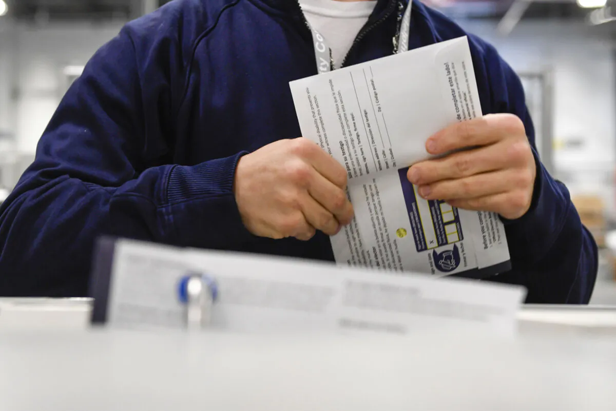 Poll workers demonstrate how ballots are received, processed, scanned, and stored on Election Day, at the Philadelphia Election Warehouse on Oct. 25. (Matthew Hatcher/Getty Images)