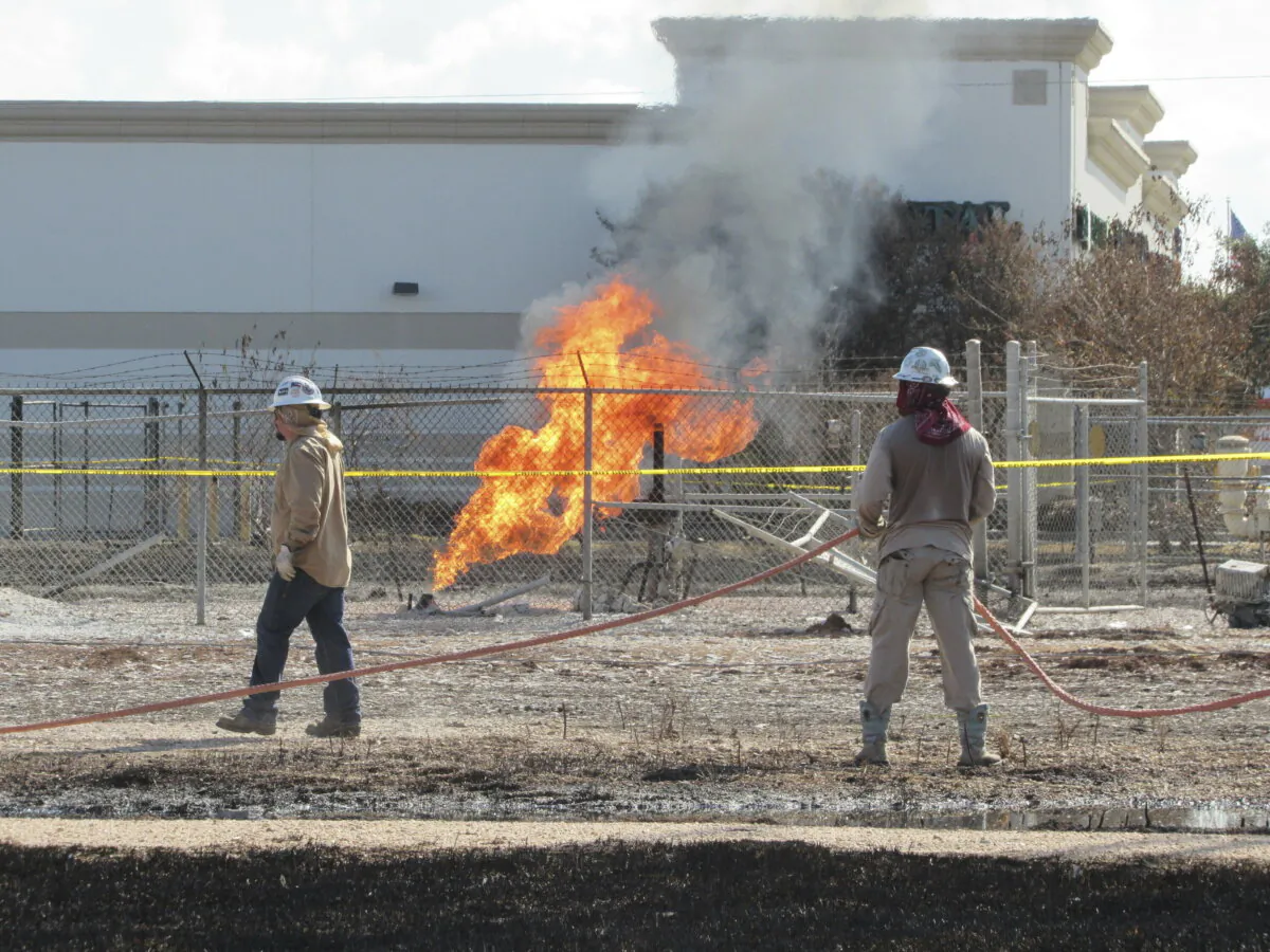 Workers stand near a pipeline fire in Deer Park, Texas, on Sept. 19, 2024. (Juan A. Lozano/AP Photo)