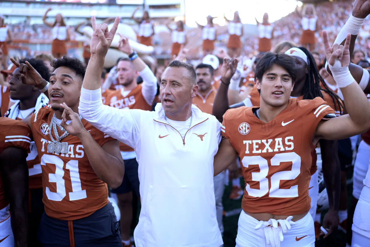 Texas head coach Steve Sarkisian (C) joins players for the school song following their win over Mississippi State in an NCAA college football game in Austin, Texas, on Sept. 28, 2024. (Eric Gay/AP Photo)