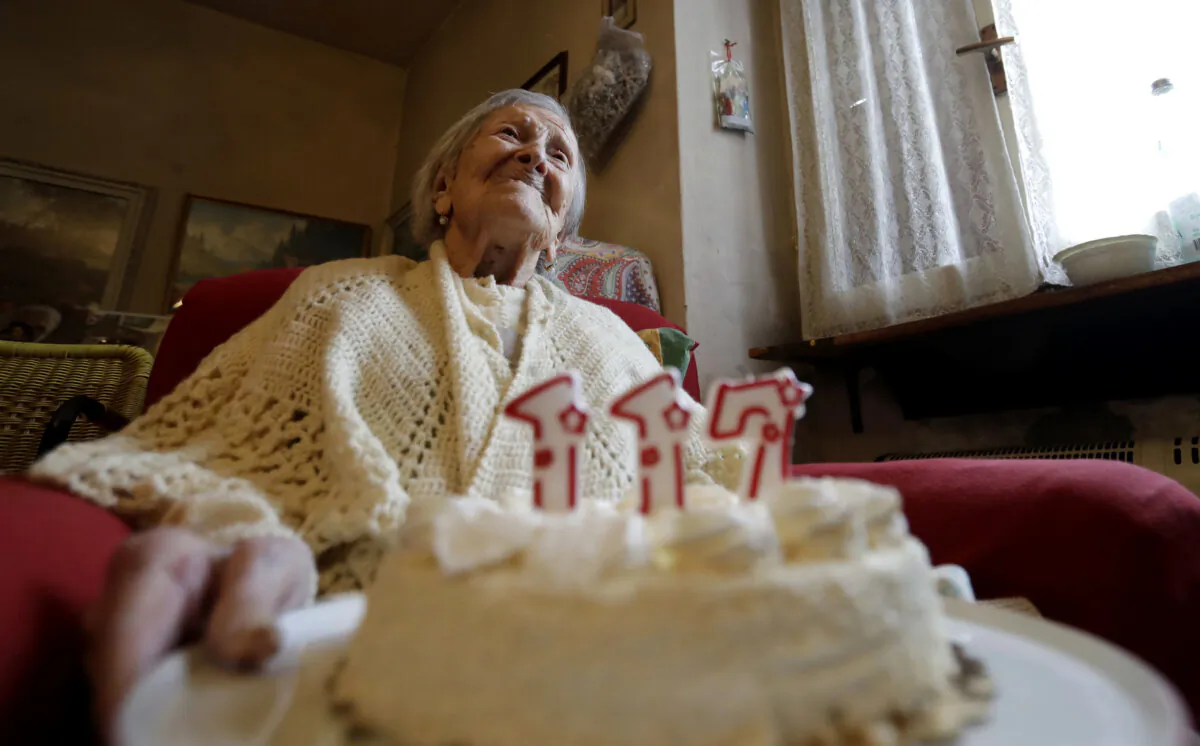 Emma Morano holds a cake with candles marking 117 years on the day of her birthday in Verbania, Italy, on Nov. 29, 2016. (Antonio Calanni/AP Photo)