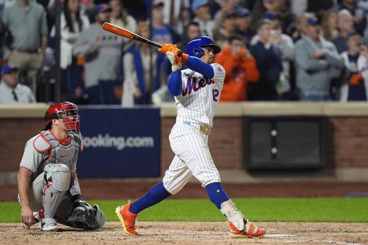 New York Mets' Francisco Lindor (12) follows through on a grand slam home run against the Philadelphia Phillies during the sixth inning of Game 4 of the National League baseball playoff series in New York on Oct. 9, 2024. (Frank Franklin II/AP Photo)