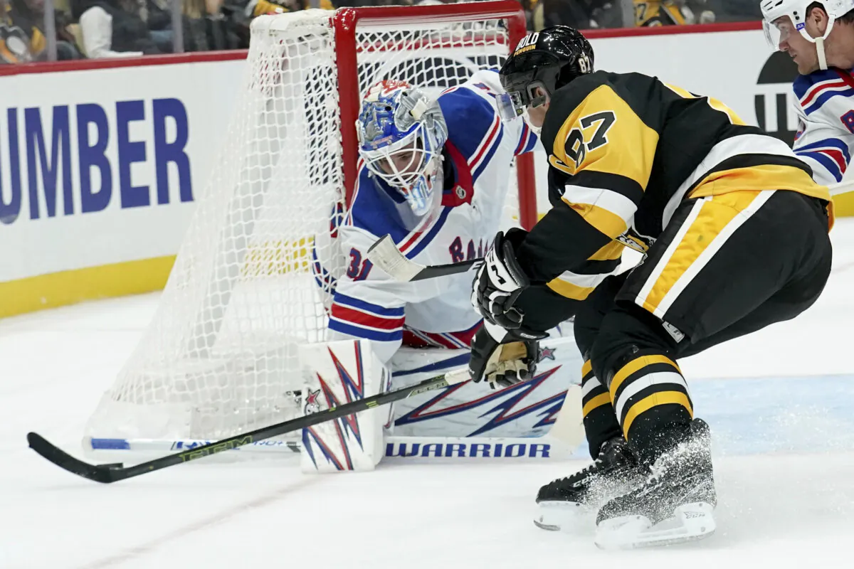 Pittsburgh Penguins' Sidney Crosby (87) reaches for the puck in front of New York Rangers goaltender Igor Shesterkin (31) during the second period of an NHL hockey game in Pittsburgh on Oct. 9, 2024. (Matt Freed/AP Photo)