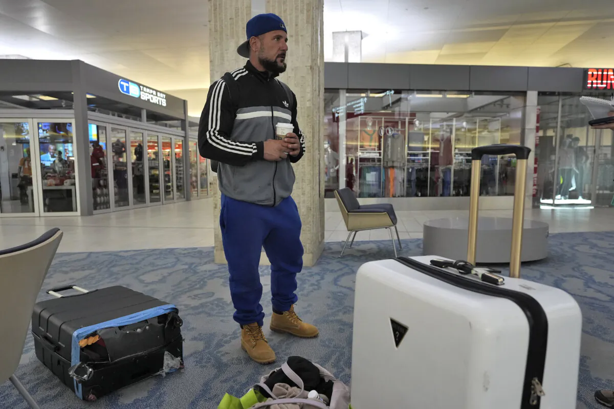 John Fedor, of New Jersey, waits for transportation help to get to a shelter after his flight was canceled Tuesday, Oct. 8, 2024, at the Tampa International Airport in Tampa, Fla., due to the possible arrival of Hurricane Milton. (Chris O'Meara/AP Photo)