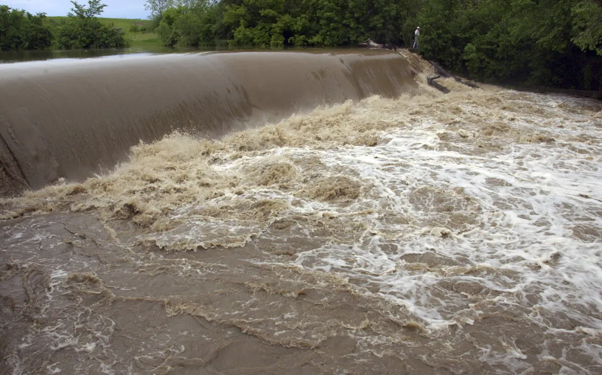 The Root River, swollen from record-level rain, flows over the Horlick Dam in Racine, Wis., on June 8, 2008. (Journal Times, Mark Hertzberg/AP Photo)