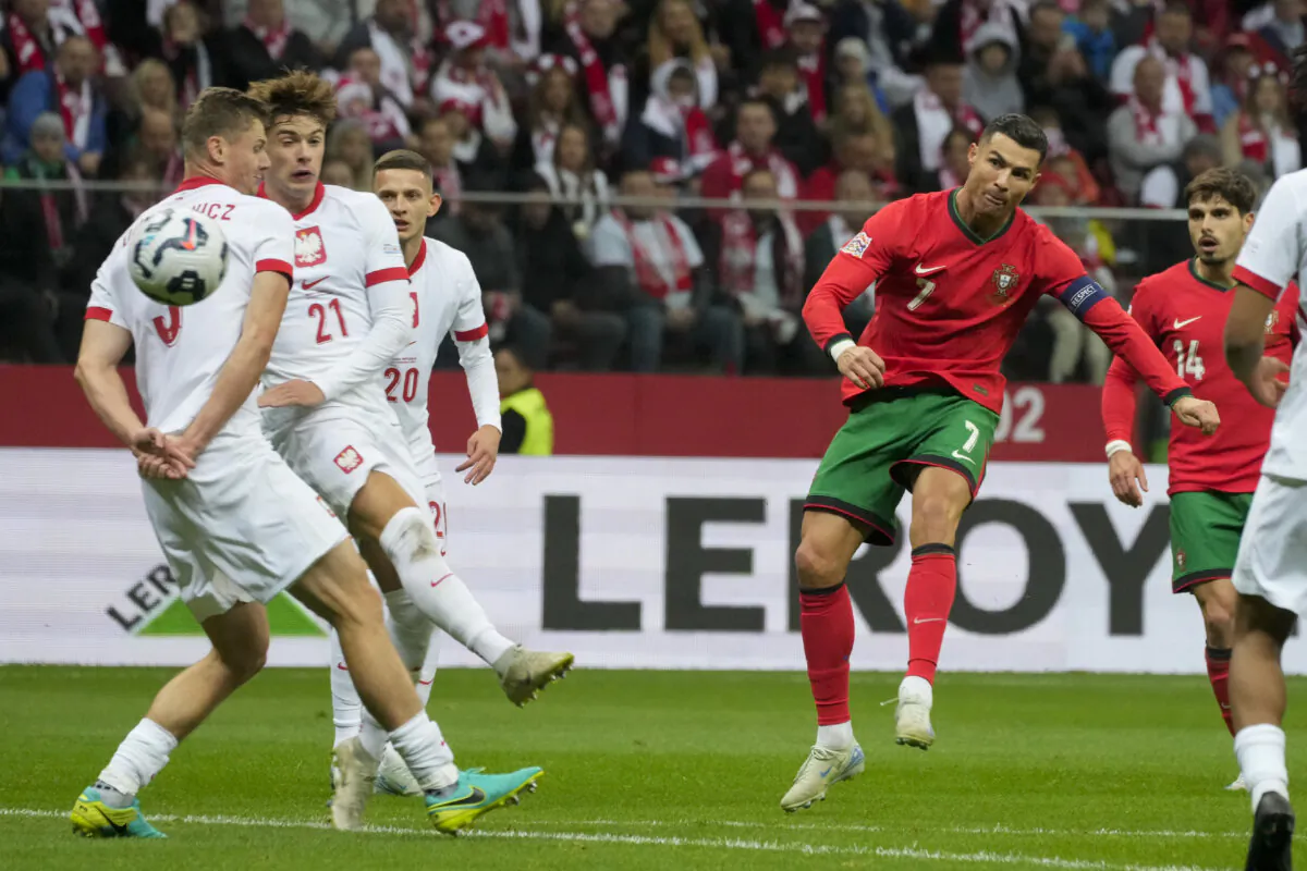 Portugal's Cristiano Ronaldo attempts a shot on goal during the UEFA Nations League soccer match between Poland and Portugal at Narodowy stadium in Warsaw, Poland, Saturday, Oct. 12, 2024. (AP Photo/Czarek Sokolowski)