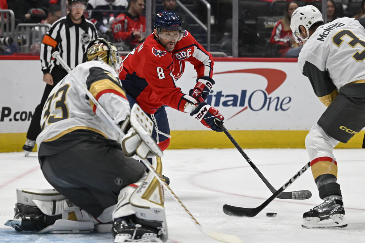 Washington Capitals left wing Alex Ovechkin, center, attempts a shot against Vegas Golden Knights goaltender Adin Hill, left, and Golden Knights defenseman Brayden McNabb (3) during the first period of an NHL hockey game in Washington, on Oct. 15, 2024. (John McDonnell/AP Photo)