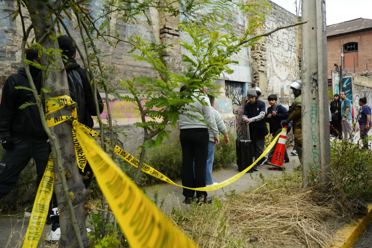 Students are escorted by security forces out of the Barros Arana National Boarding School (INBA) due to a fire in Santiago, Chile, on Oct. 23, 2024. (Esteban Felix/AP Photo)