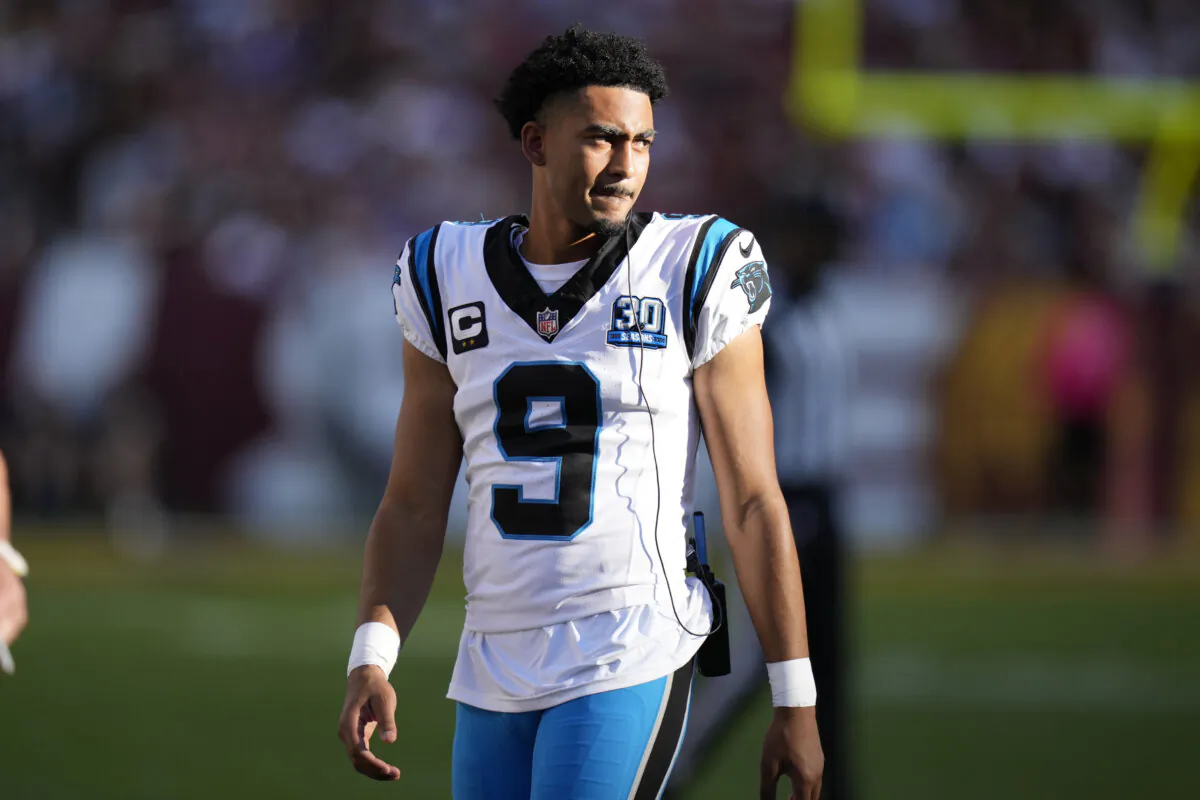 Carolina Panthers quarterback Bryce Young watches from the sideline during the first half of an NFL football game against the Washington Commanders, Sunday, Oct. 20, 2024, in Landover, Md. (AP Photo/Stephanie Scarbrough)