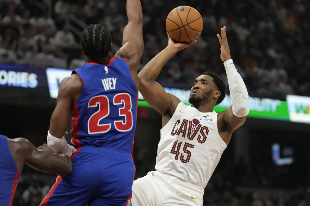 Cleveland Cavaliers guard Donovan Mitchell (45) looks to shoot as Detroit Pistons guard Jaden Ivey (23) defends in the first half of an NBA basketball game, Friday, Oct. 25, 2024, in Cleveland. (AP Photo/Sue Ogrocki)