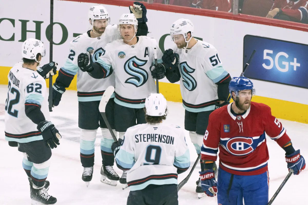 Seattle Kraken's Jaden Schwartz (17) celebrates his goal with teammates Brandon Montour (62), Oliver Bjorkstrand (22), Shane Wright (51) and Chandler Stephenson (9) during the first period of an NHL hockey game against the Montreal Canadiens in Montreal, on Oct. 29, 2024. (Christinne Muschi/The Canadian Press via AP)