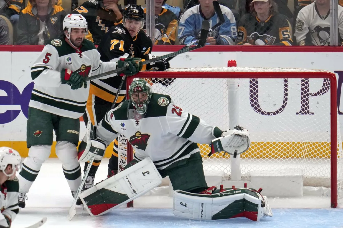 Pittsburgh Penguins' Rickard Rakell gets a shot past Minnesota Wild goaltender Marc-Andre Fleury for a goal as Jake Middleton (5) defends Evgeni Malkin (71) during the first period of an NHL hockey game in Pittsburgh, on Oct. 29, 2024. (Gene J. Puskar/AP Photo)