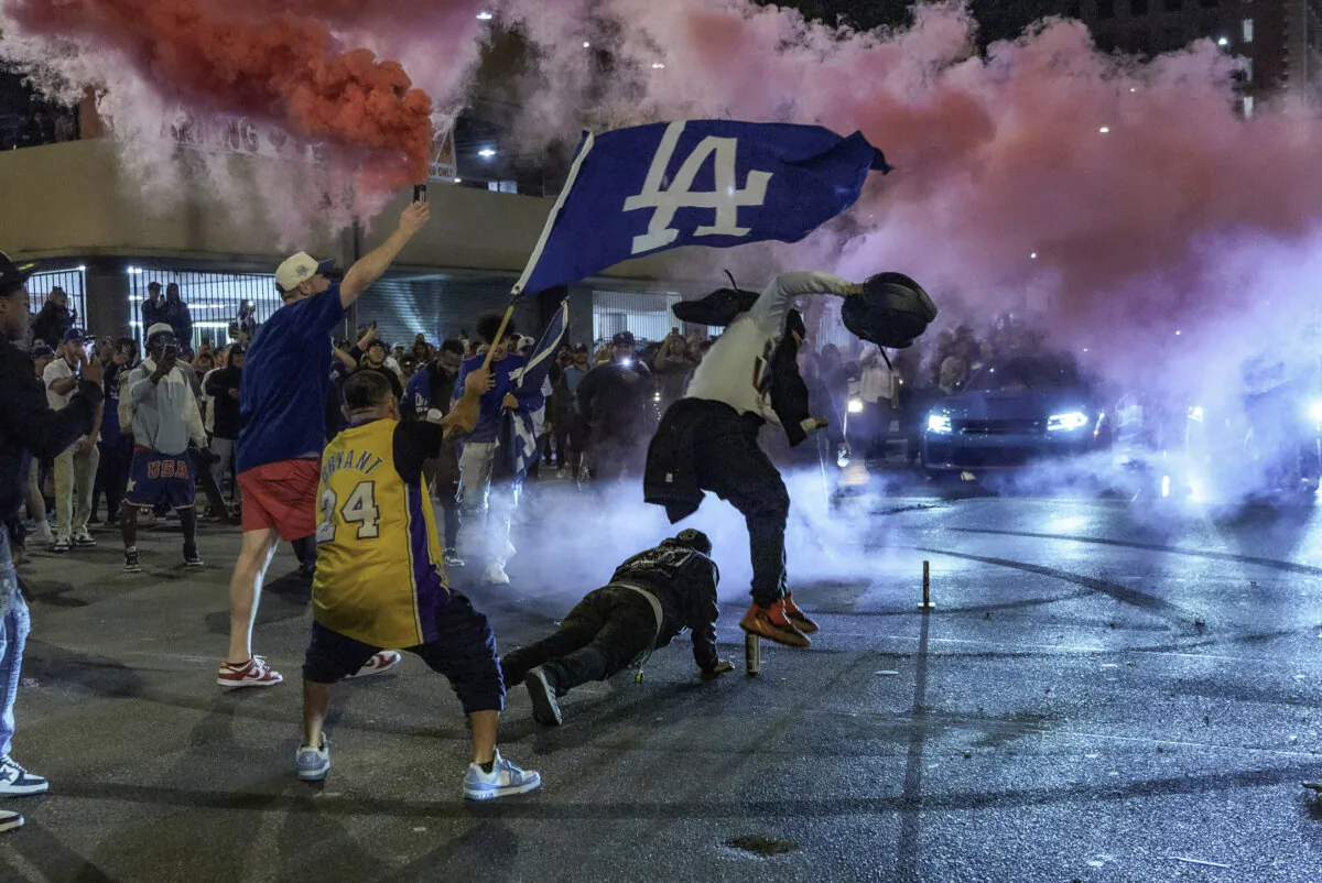 Fans celebrate on the streets after the Los Angeles Dodgers won against the New York Yankees in the baseball World Series in Los Angeles on Oct. 30, 2024. (Damian Dovarganes/AP Photo)