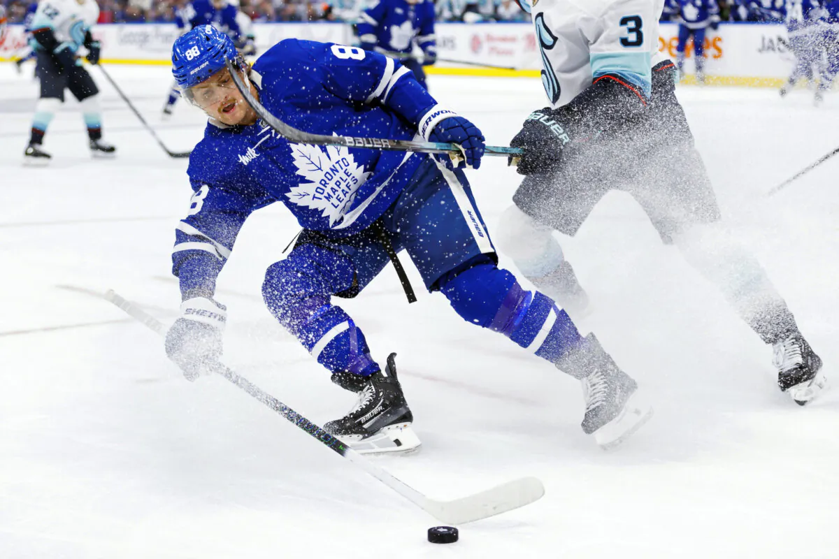 Toronto Maple Leafs' William Nylander (88) battles for the puck during the second period of an NHL hockey game against the Seattle Kraken in Toronto, on Oct, 31, 2024. (Cole Burston/The Canadian Press via AP)