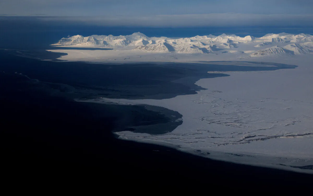 A general view of snowcapped mountains and the Arctic Ocean on the coast of Svalbard near Longyearbyen, Norway, on April 5, 2023. (Lisi Niesner/Reuters)