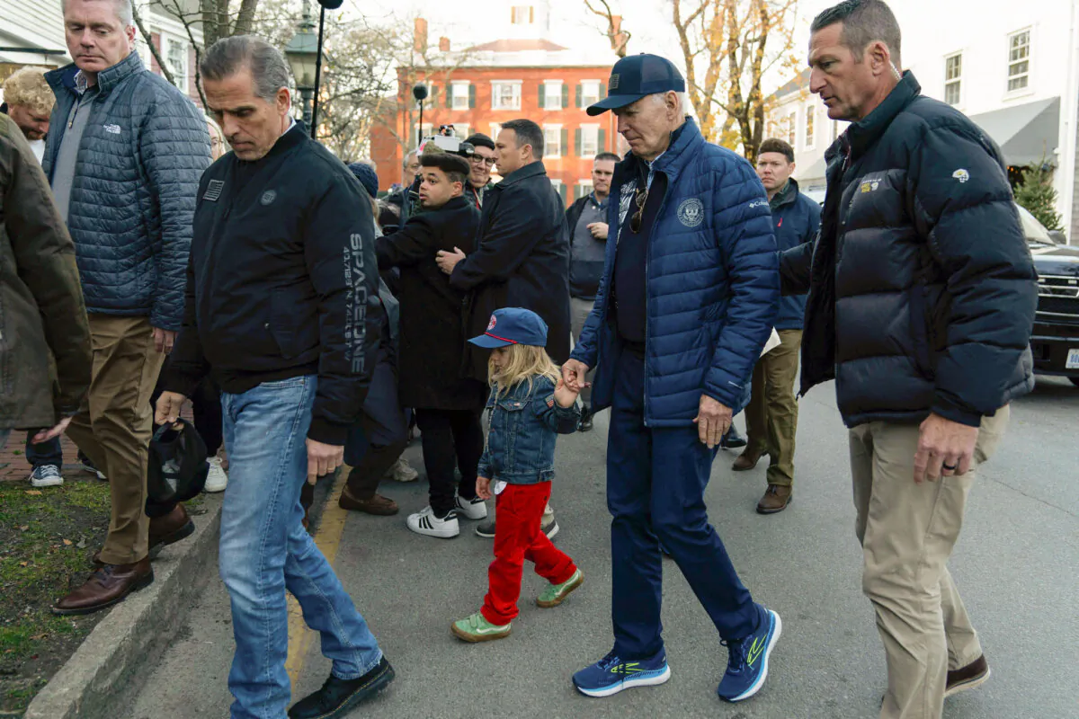 President Joe Biden (center R) holds hands with his grandson Beau as they walk with Hunter Biden (L) in downtown Nantucket, Mass., on Nov. 29, 2024. (Jose Luis Magana/AP Photo)
