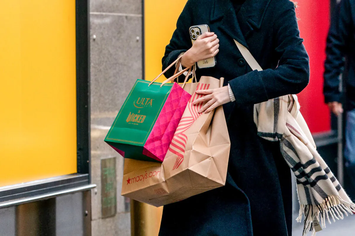 A person walks down a street with shopping bags in New York on Nov. 29, 2024. (David Dee Delgado/Getty Images)