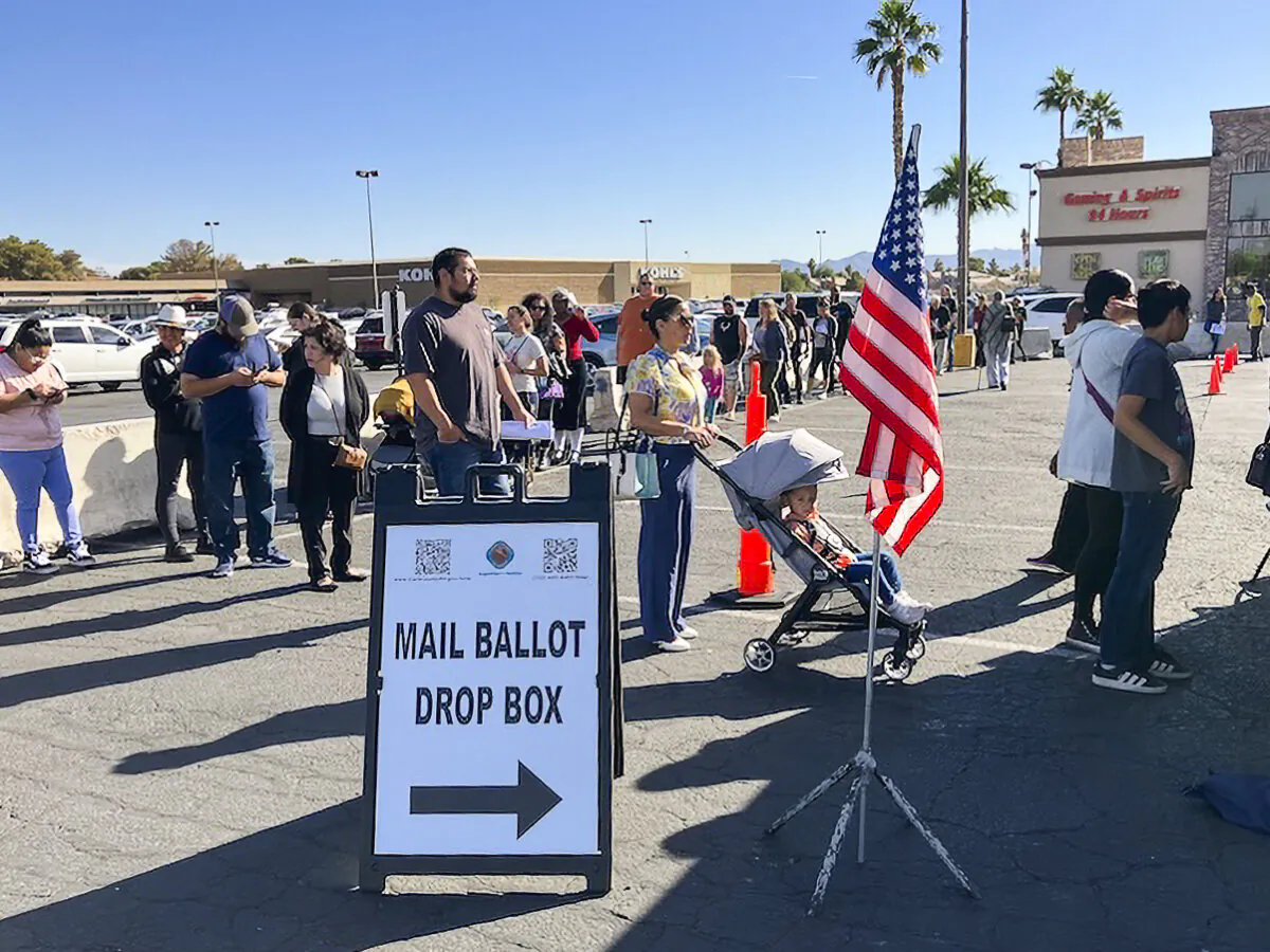 Voters wait in 25-minute lines to cast ballots at Nellis Crossing Shopping Center on the east side of Las Vegas on Nov. 1, 2024. (John Haughey/The Epoch Times)