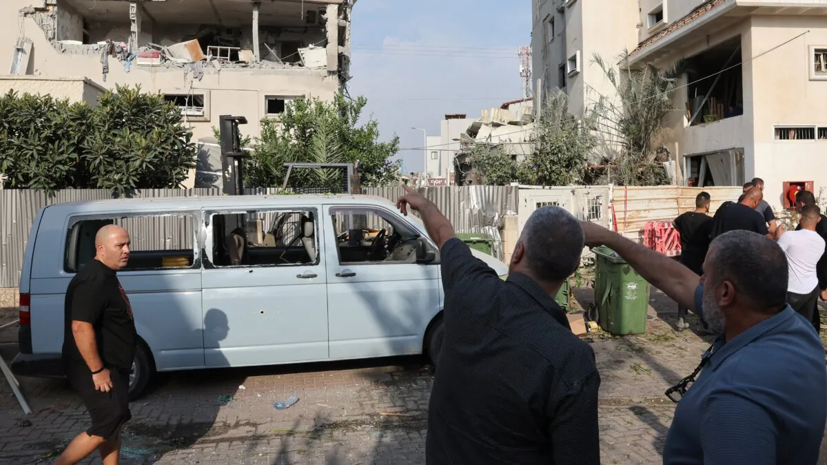 Residents point at a damaged building following a rocket attack from southern Lebanon that targeted the central Israeli-Arab city of Tira, amid the ongoing war between Israel and Hezbollah, on Nov. 2, 2024. (Jack Guez/AFP via Getty Images)