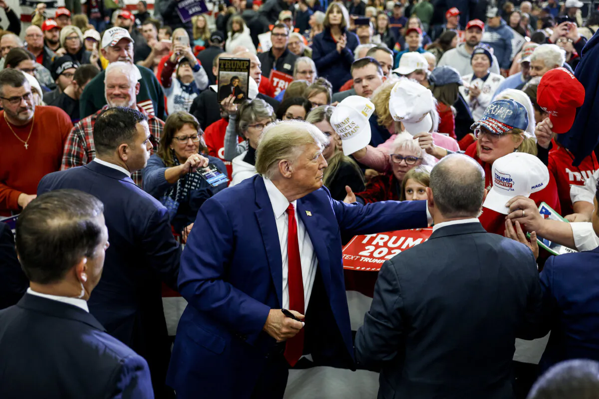 Republican presidential candidate and former President Donald Trump signs autographs after speaking at a campaign rally in Mason City, Iowa, on Jan. 5, 2024. (Anna Moneymaker/Getty Images)