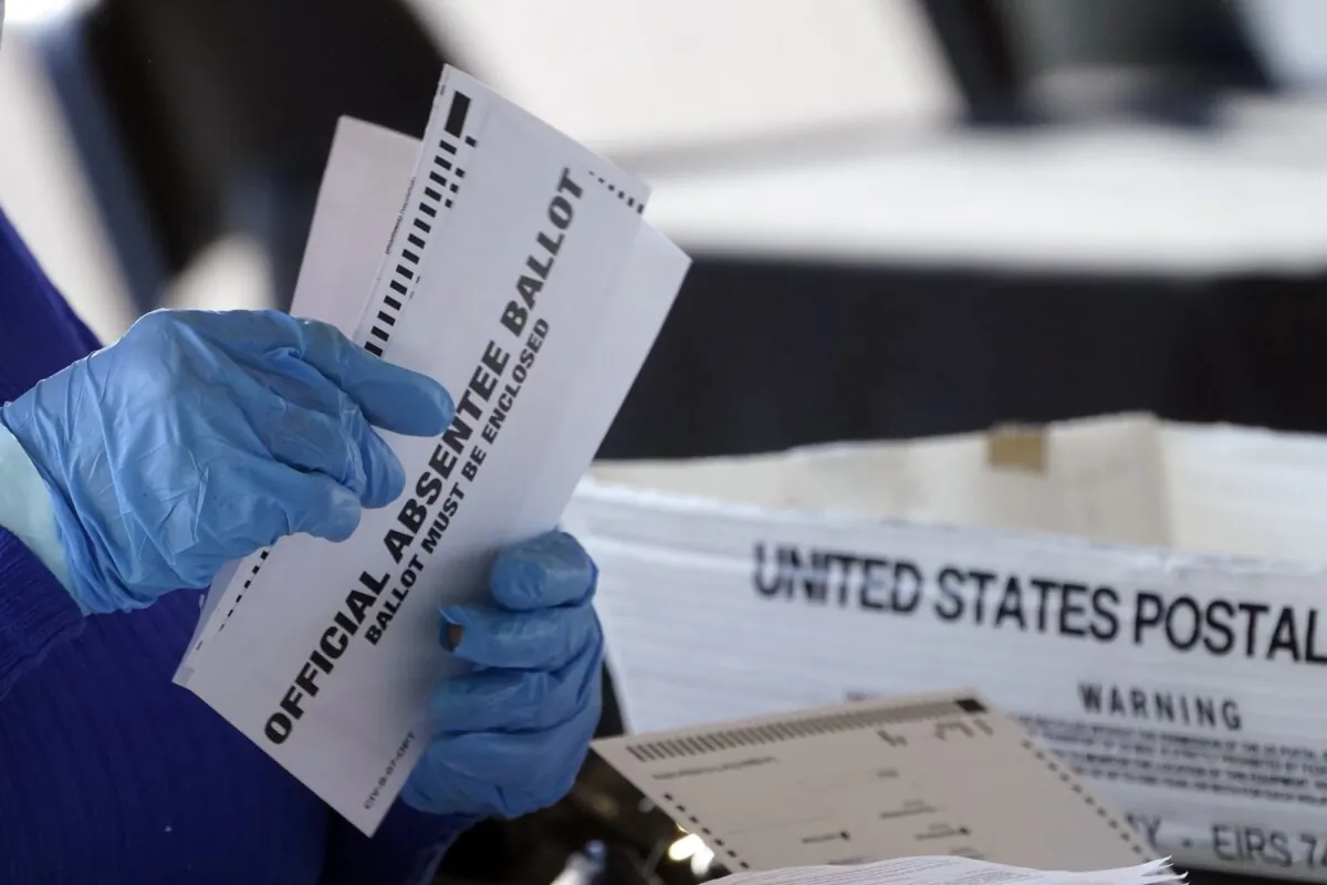 A worker at the Fulton County Board of Registration and Elections processes absentee ballots at the State Farm Arena in Atlanta on Nov. 2, 2020. (John Bazemore/AP Photo)