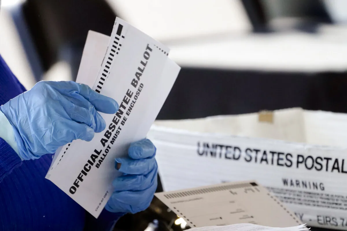 A worker at the Fulton County Board of Registration and Elections processing absentee ballots at the State Farm Arena in Atlanta on Nov. 2, 2020. (John Bazemore/AP Photo)