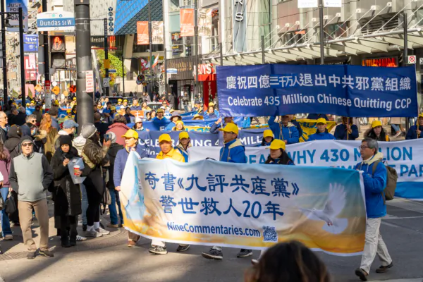 People watch a parade in downtown Toronto on Nov. 2, 2024, marking the 20th anniversary of the publication of "Nine Commentaries on the Communist Party," a book that details the Chinese regime's totalitarian rule and human rights abuses. (The Epoch Times)
