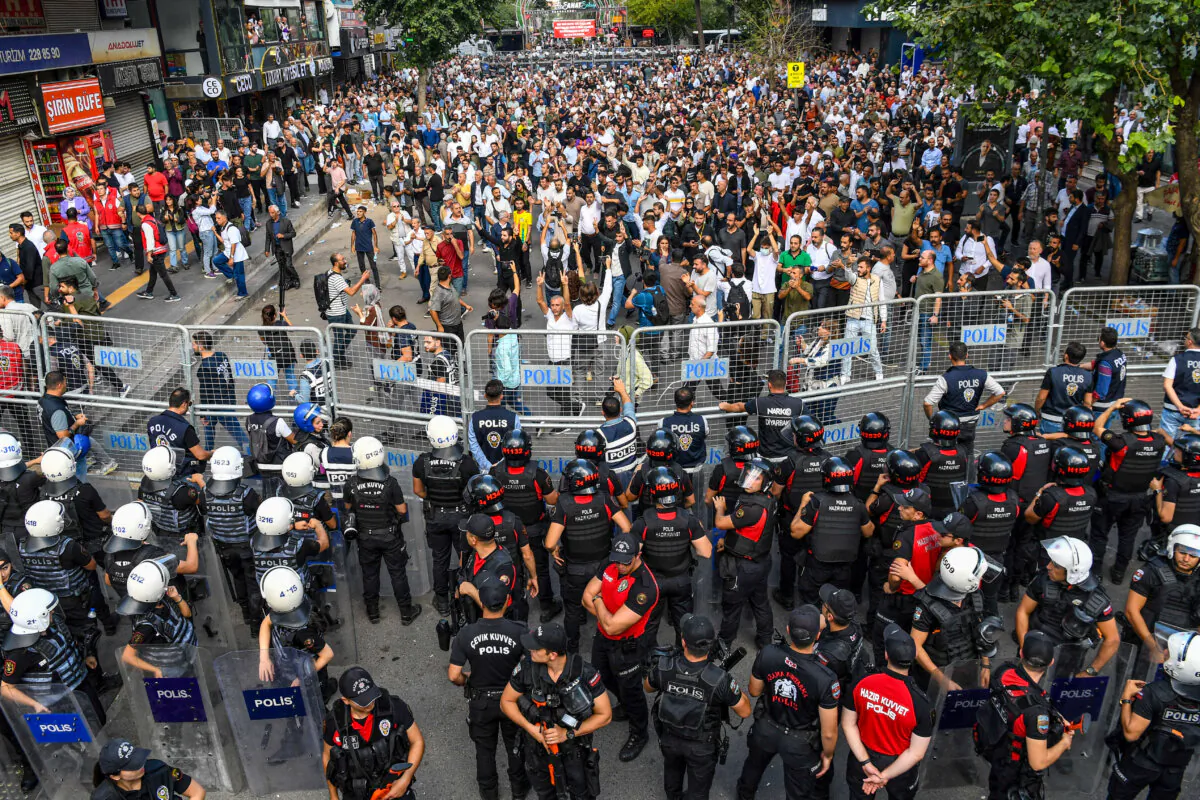 Turkish security forces stand behind barricades as protesters gather at a rally organised by the pro-Kurdish Equality and Democracy (DEM) Party, dubbed "Freedom Rally Against Isolation," against the continued isolation of imprisoned Kurdistan Workers' Party (PKK) founder Abdullah Ocalan in Diyarbakir, Turkey, on Oct. 13, 2024. (Ilyas Akengin/AFP via Getty Images)