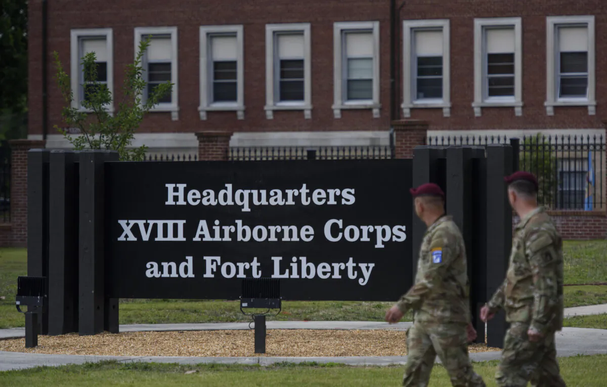 Soldiers walk pass a newly unveiled sign after a redesignation ceremony officially renaming the military installation Fort Liberty, in Fayetteville, N.C., on June 2, 2023. Fort Liberty, formerly known as Fort Bragg, is the largest military installation by population in the United States. (Melissa Sue Gerrits/Getty Images)