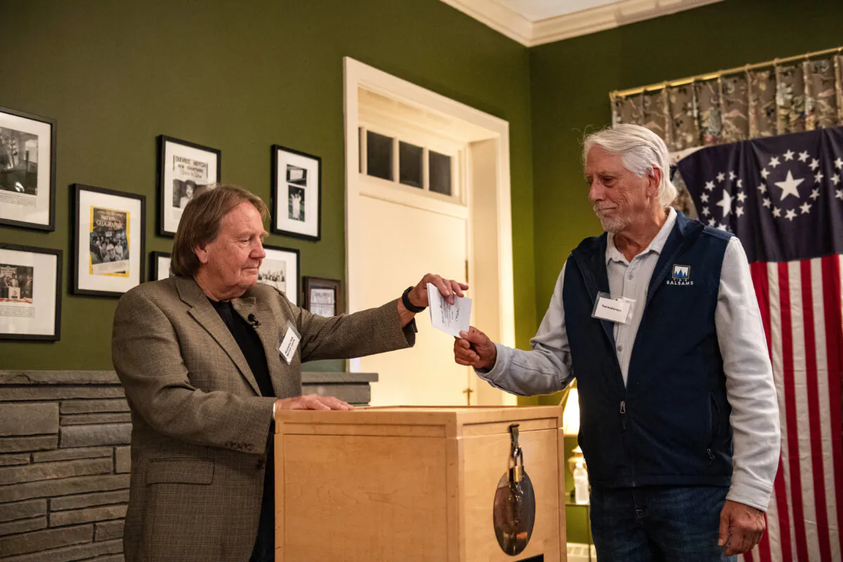 Residents of Dixville Notch cast their ballots in the election at midnight in the living room of the Tillotson House at the Balsams Grand Resort, marking the first votes in the U.S. election, in Dixville Notch, N.H., on Nov. 5, 2024. (Joseph Prezioso/AFP via Getty Images)