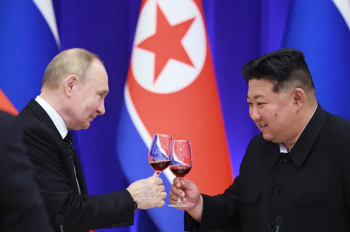 Russian President Vladimir Putin and North Korean leader Kim Jong Un toast during a reception at the Mongnangwan Reception House in Pyongyang, North Korea, on June 19, 2024. (Vladimir Smirnov/Pool/AFP via Getty Images)