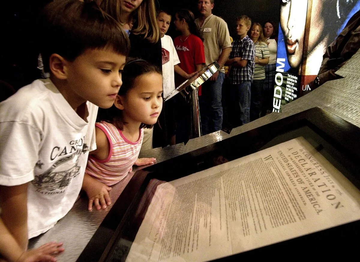 Conor Park, 8, and his sister Ripley Park, 7, look at an original printed version of the Declaration of Independence at the Capitol in Phoenix, on Oct. 8, 2003. (Matt York/AP Photo)