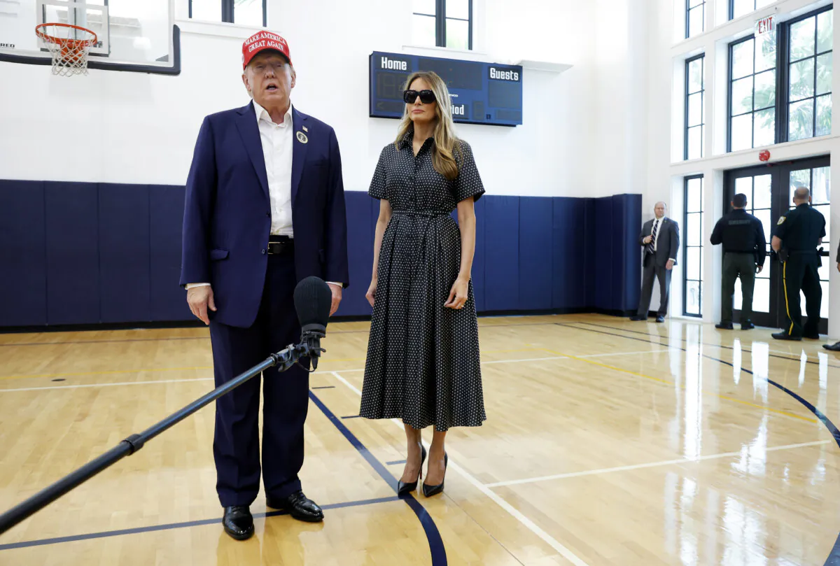 Republican presidential nominee former President Donald Trump and his wife, former First Lady Melania Trump, talk to reporters after casting their votes at the polling place in the Morton and Barbara Mandel Recreation Center on Election Day in Palm Beach, Fla., on Nov. 5, 2024. (Chip Somodeville/Getty Images)