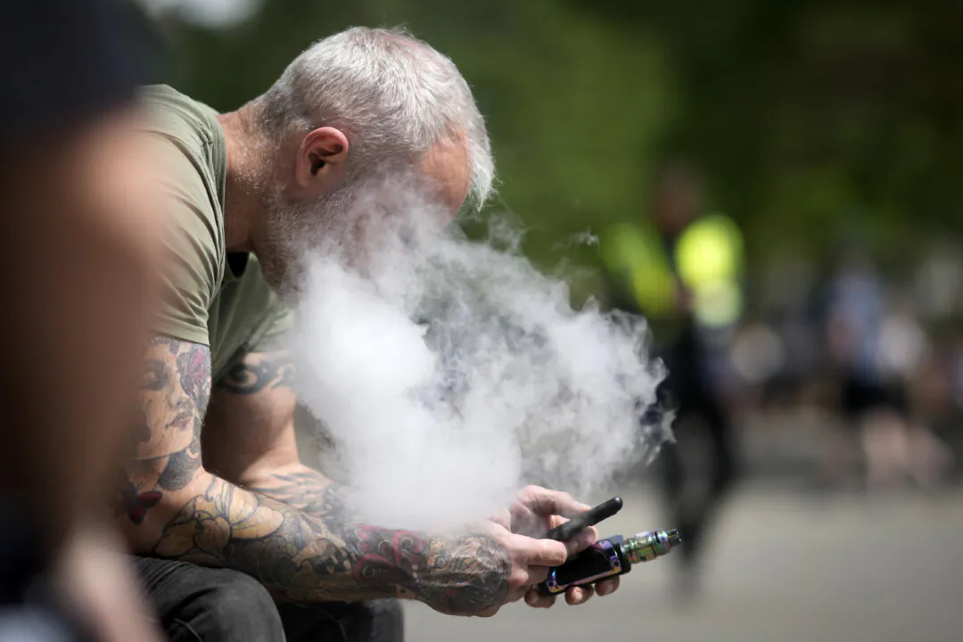 A man  smokes a vape device in Manchester, England, on May 30, 2023. (Christopher Furlong/Getty Images)