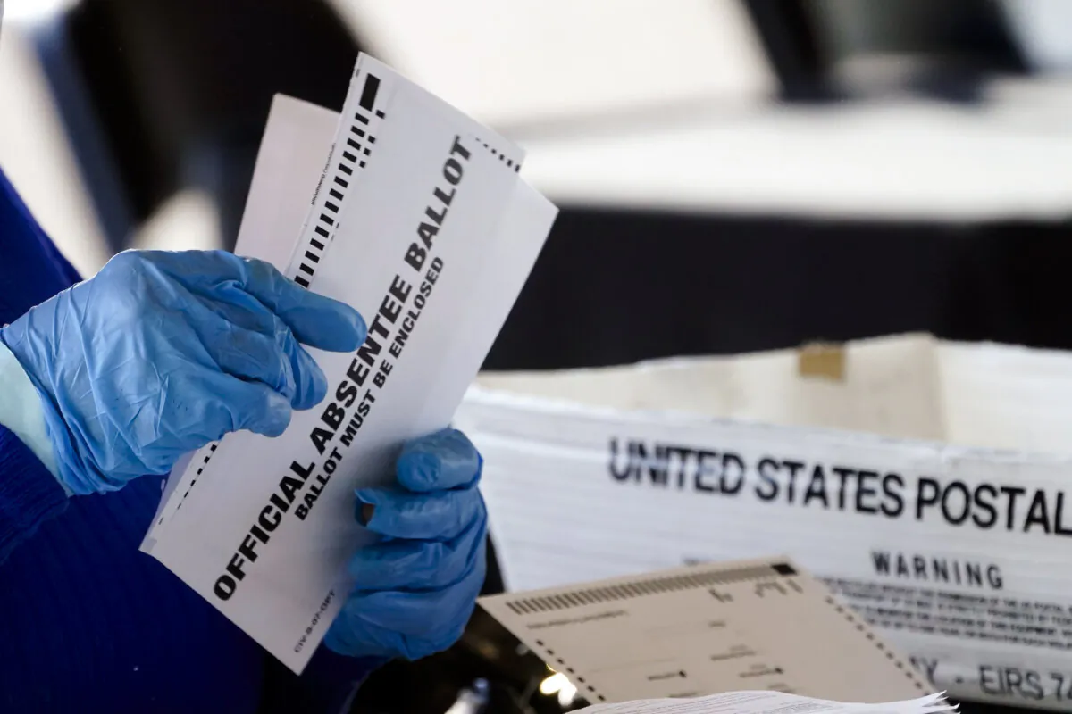 A worker at the Fulton County Board of Registration and Elections processes absentee ballots at the State Farm Arena in Atlanta on Nov. 2, 2020. (John Bazemore/AP Photo)