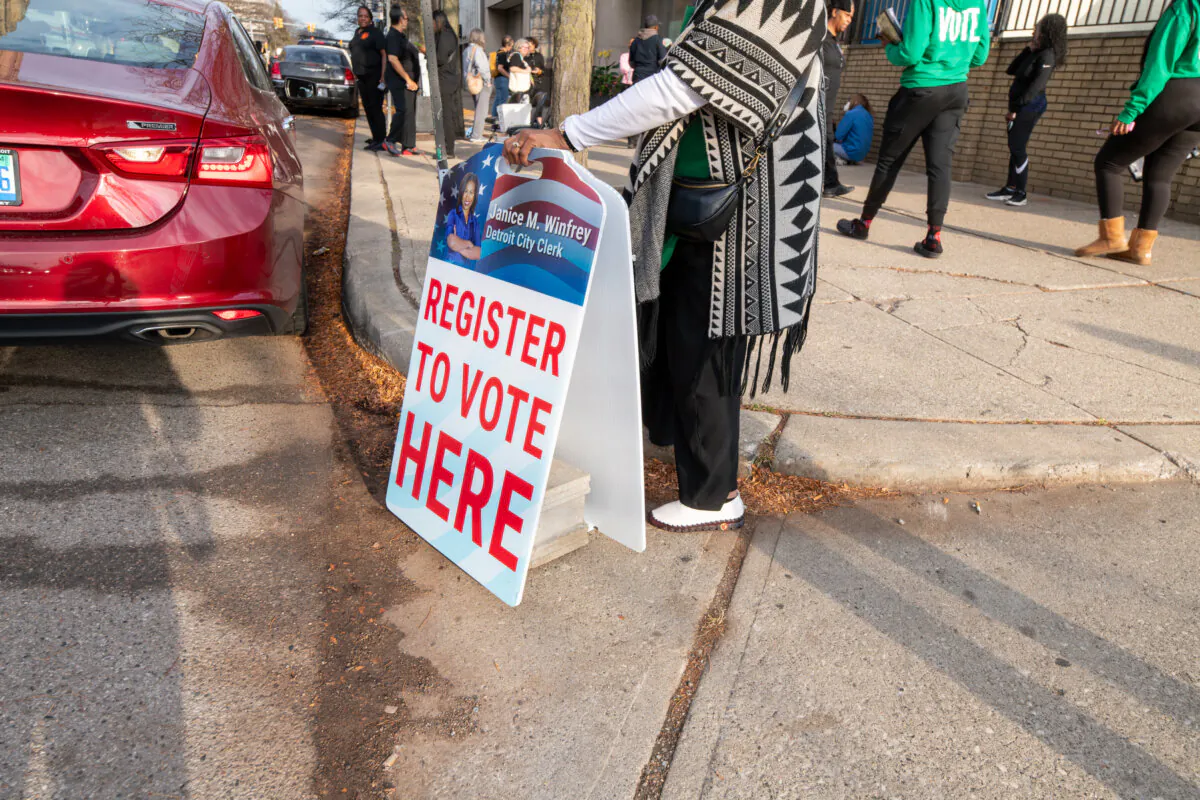 People waiting to register to vote for same-day voter registration outside of the Detroit Department of Elections headquarters in Detroit on Nov. 5, 2024. (Davslens Photography for The Epoch Times)