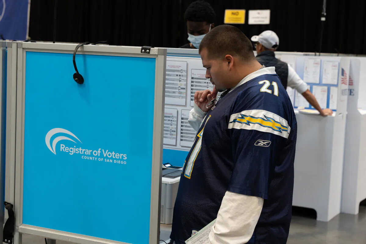 First time San Diego voter Angel E. Madueno votes through a ballot marking device at the San Diego County Registrar of Voters on Nov 5, 2024. (Jane Yang/The Epoch Times)