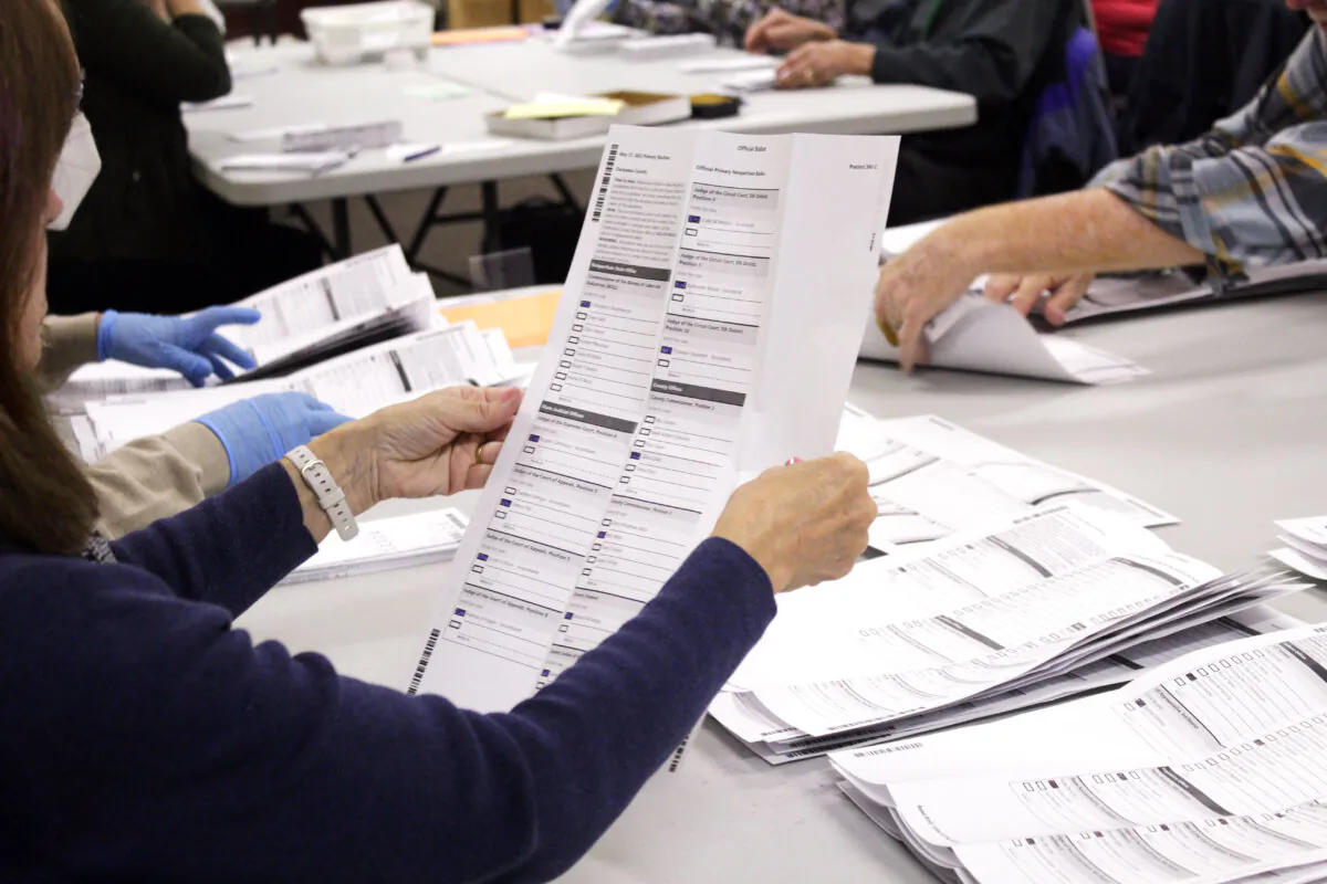 An election worker examines a ballot at the Clackamas County Elections office in Oregon City, Ore., on May 19, 2022. (Gillian Flaccus/AP Photo)