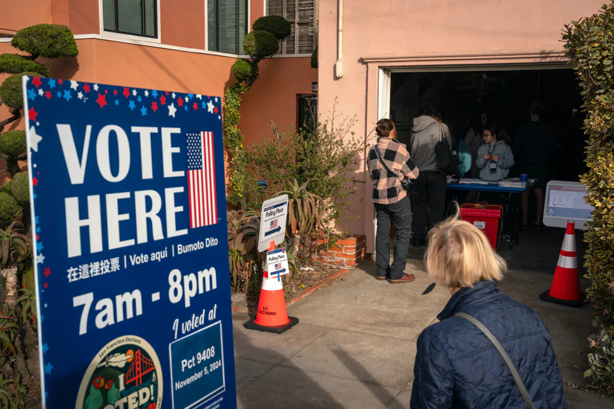 Voters check in before casting their ballots at a polling place inside a residential garage next to Ocean Beach in San Francisco on Nov. 5, 2024. (Loren Elliott/Getty Images)