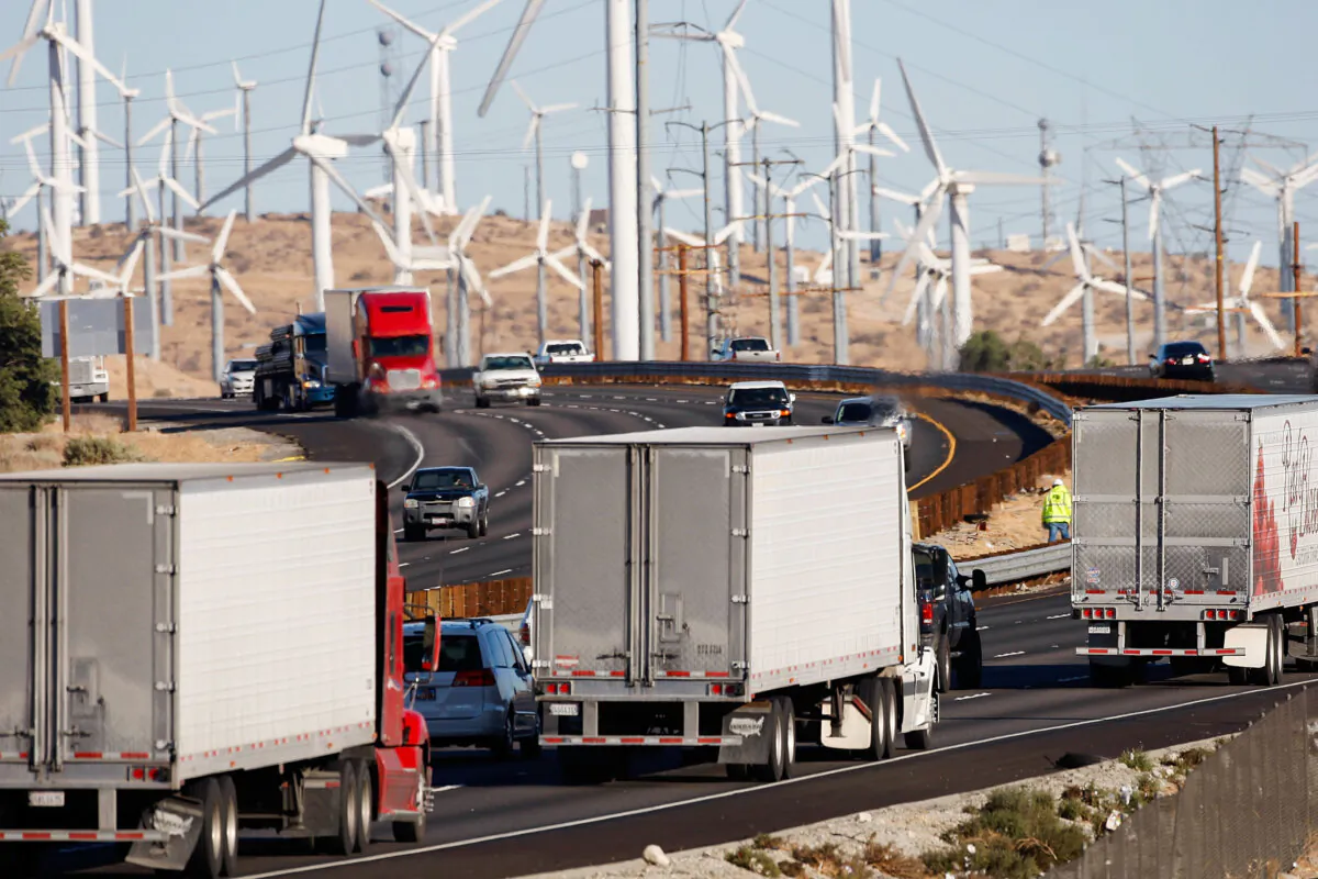 Diesel trucks and cars pass windmills along the 10 freeway near Banning, Calif., on Dec. 8, 2009. (David McNew/Getty Images)